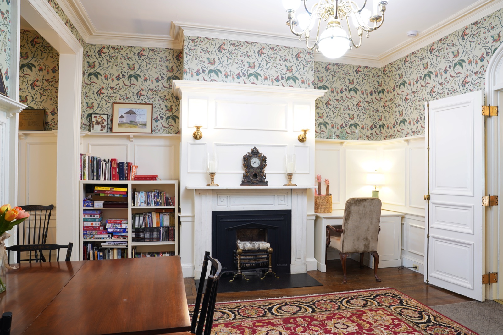 Cozy library and reading room with fireplace at John Bertram House of Salem