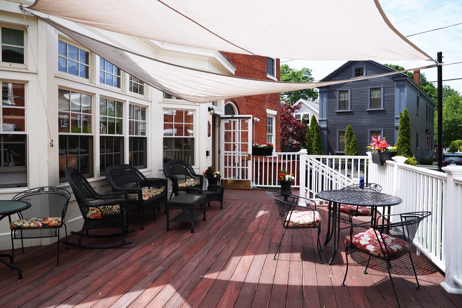 Outdoor deck with seating and shade at John Bertram House of Salem