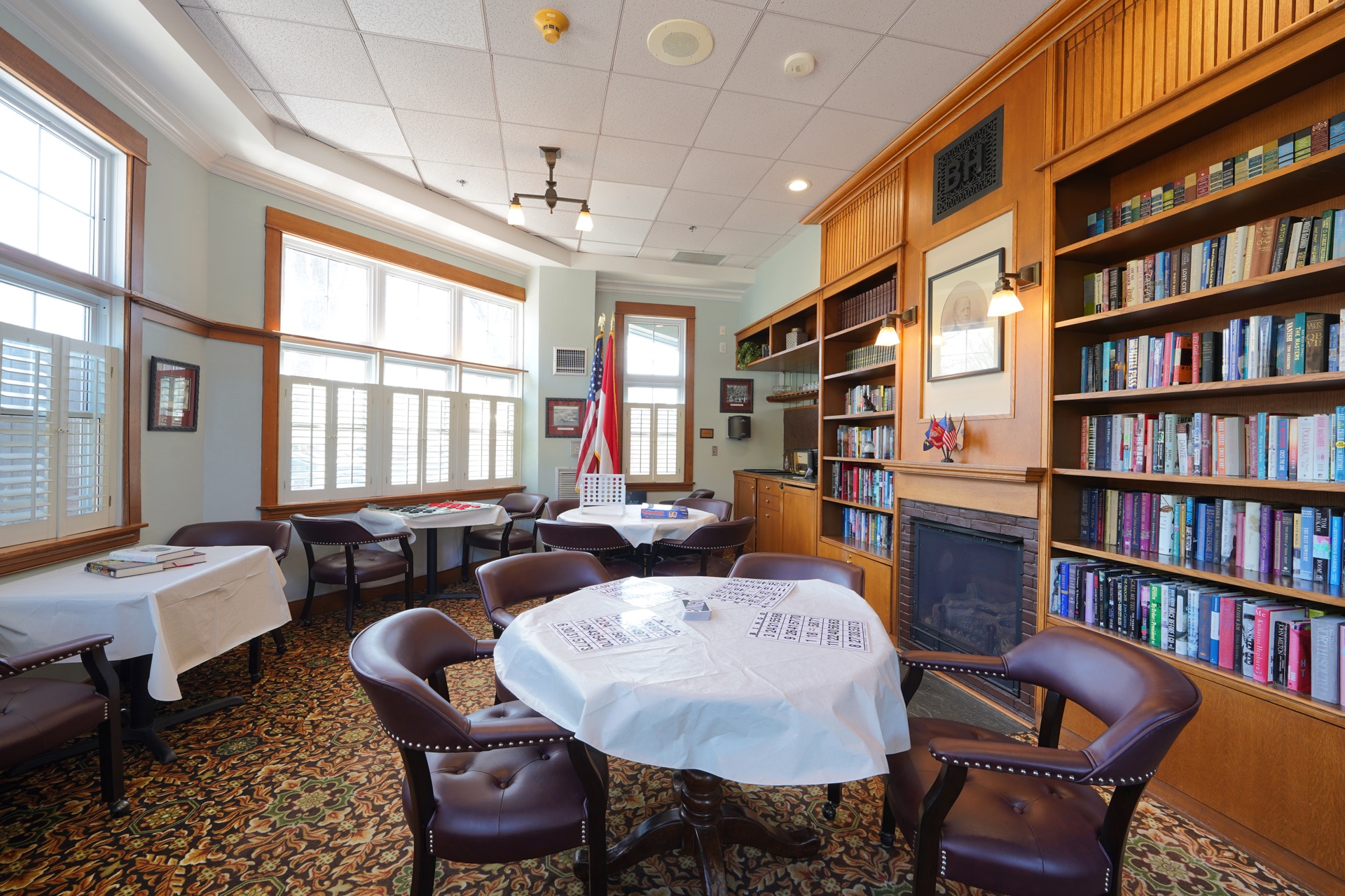 Library and reading area with a fireplace